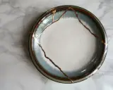 Une assiette ébréchée, réparée avec de l'or, témoigne de la beauté de la résilience.