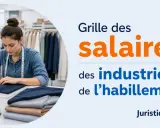 Une couturière travaille sur une machine à coudre, illustrant la grille des salaires des industries de l'habillement.