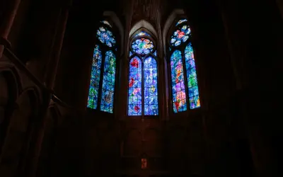 Vitraux de Chagall à Reims, illuminant l'intérieur sombre d'une cathédrale gothique.